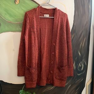 Cozy burnt orange and black long knit sweater. Perfect for fall.
